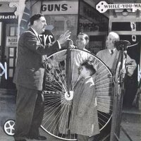 March 1956 - L to R, Joe Giuffre, PDG, member from 1954 until his passing, Vince Borelli, member from 1955 to 1962, his young nephew Emil, and his father Albert Borelli. All are standing around the penny-farthing bicycle in front of Borelli Hardware and Sporting Goods, 4537 Mission St.