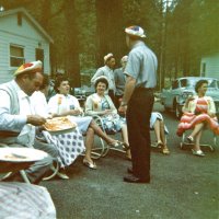 May 1961 - District 4C-4 Convention, Hoberg’s Resort, Lake County - L to R: member, wife, wife, Estelle & Charlie Bottarini (standing near tree), member, member (foreground), Eva Bello (seated).