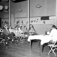 May 1961 - District 4C-4 Convention, Hoberg’s Resort, Lake County - Front row audience, on left are two GE Lions members, Ron Faina and an unknown member, with other Lions in the Cabinet Meeting(?)