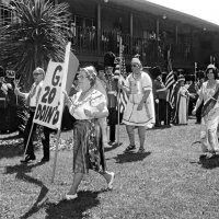 May 1977 - District 4-C4 Convention, El Rancho Tropicana, Santa Rosa - L to R: Ozzie & Elva Buoncristiani (with sign, gypsies, 1960), Handford & Margot Clews (romans, 1961), and Frances Speciacci (french maids, 1962). The Millbrae Lions are in background dressed as Queen’s Guards.