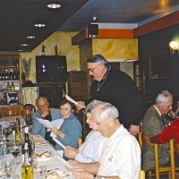 12/8/04 - Club Christmas Party, Ristorante Mar, Pacifica - Members and guests singing Christmas carols, led by Handford Clews (standing). From left: Ted Wildenradt, and a guest. Opposite side, center is Mike & Lorraine Castagnetto, Estelle & Charlie Bottarini. Behind Handford is Ward & Diane Donnelly.