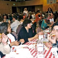 2/25/06 - 24th Annual Crab Feed at the Janet Pomeroy Center For The Handicapped - 470 attendees - Aaron (blue hat) & Jesusa Straus, and Zenaida Lawhon enjoying crab with some of their guests.
