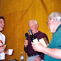 2/25/06 - 24th Annual Crab Feed at the Janet Pomeroy Center For The Handicapped - 470 attendees - Roxanne Gentile is the lucky winner of a box of candy and a nice bottle of wine. Ward Donnelly announcing and Bob Lawhon presenting the prize.