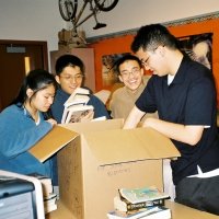 3/29/06 - Lowell Leo Club members unpacking and preparing donated books for Some Book Buddies.