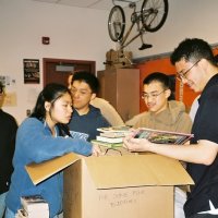 3/29/06 - Lowell Leo Club members unpacking and preparing donated books for Some Book Buddies.