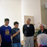 12/12/05 - Lowell Leo Club at Coventry Presbyterian Church, San Francisco - A Leo member making comments about their donation. David Brown, with Coventry Food Pantry, and Lion Bob Lawhon are on the far right.
