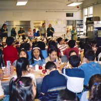 11/22/05 - Mission Educational Center, San Francisco - Students and teachers wait patiently for their lunch to be served. Across the back are L to R: Lions Sheriar Irani, Al Gentile, Joe Farrah, Bre Martinez, cafeteria staff, Lyle Workman, and Aaron Straus working on the details.
