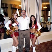 10/17/06 - 49er Night at the Cliff House, San Francisco - Lion George Salet happily poses with Gold Rush Cheerleaders Amy and Krissie.