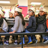 11/16/17 - Serving Thanksgiving Luncheon, Mission Educational Center - Immigrant students watch other students perform while celebrating their first Thanksgiving at Mission Education Center. (Mira Laing/Special to S.F. Examiner)