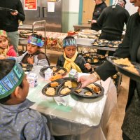 11/16/17 - Serving Thanksgiving Luncheon, Mission Educational Center - Immigrant students are served lunch at their first Thanksgiving at Mission Education Center. (Mira Laing/Special to S.F. Examiner)