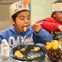 11/16/17 - Serving Thanksgiving Luncheon, Mission Educational Center - Immigrant students feast on lunch at their first Thanksgiving at Mission Education Center. (Mira Laing/Special to S.F. Examiner)