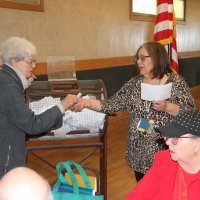 4/18/18 - 2018 Y & C Drawing, IASC - Guest Arline Thomas handing Lion Viela du Pont a winning ticket, with Lion Sharon Eberhardt looking on.