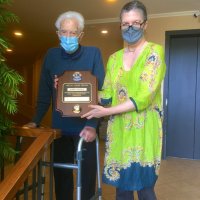 4/11/21 - Gentile residence, San Mateo - Al Gentile with his daughter Roxanne Gentile posing with Al’s Melvin Jones Fellowship plaque. Al was awarded the fellowship for his many years of outstanding service to our Club, and the community.