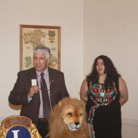 8-17-22 - 73rd Installation of Officers, Italian American Social Club - Mario Benavente installing Iliana Escadero as a new Lion while informing her, and the audience, about Lionism.