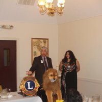 8-17-22 - 73rd Installation of Officers, Italian American Social Club - Mario Benavente installing Iliana Escadero as a new Lion while informing her, and the audience, about Lionism. Bob Lawhon on the left edge.