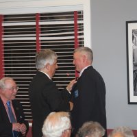 7-19-23 - Basque Cultural Center, South San Francisco - 74th Installation of Officers - PDG Mario Benavente, center, pinning Steve Martin with his president’s pin, while outgoing President Bob Lawhon looks on.