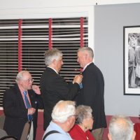 7-19-23 - Basque Cultural Center, South San Francisco - 74th Installation of Officers - PDG Mario Benavente, center, pinning Steve Martin with his president’s pin, while outgoing President Bob Lawhon looks on.