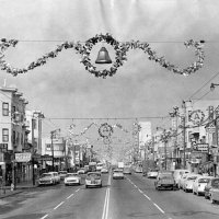 7-24-23 - Facebook group San Francisco Remembered - Christmas decorations along Mission Street at Leo Street, looking north. S. F. Public Library History Center.