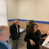 3-20-24 - Clinic by the Bay Tour, 35 Onondaga Ave., San Francisco - In one of three examination rooms are, l to r, George Salet, Bill Graziano, Sharon Eberhardt (partly hidden), and our tour guide, Iliana Escudero.
