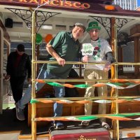 3-16-24 - St. Patrick’s Day Parade & Festival, downtown San Francisco - Bill Graziano, on the right, riding a motorized cable car in the parade.