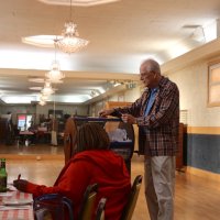 4-19-23 - Italian American Social Club, San Francisco - YCA Drawing - Chairman Lyle Workman get the drum ready for the next winner to be drawn as Connie Bridgewater (seated), with the Ocean-Ingleside Lions Club, waits for the next draw.