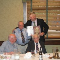 8-21-24 - 75th Installation of Officers, Basque Cultural Center, South San Francisco - Bob Lawhon, left, presenting Stephen Martin with two albums; one of the year’s club bulletins, and one of the year in photos. Seated are Bill Graziano and Joe Farrah.