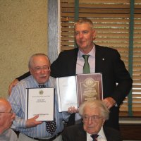 8-21-24 - 75th Installation of Officers, Basque Cultural Center, South San Francisco - Stephen Martin, right, with Bob Lawhon displaying his two albums and Past President’s plaque just received. Seated are Bill Graziano and Joe Farrah.