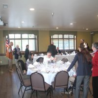 8-21-24 - 75th Installation of Officers, Basque Cultural Center, South San Francisco - Lions and guests floating into the banquet room talking and finding a good seat. L to R; foreground: Soonae Kang and Eleanor Britter; seated: Meme Jung and Mike Foti, Maryah Tucker (far right); back: George Leeds, Bob & Zenaida Lawhon, Bill Graziano, Stephen Martin, and Mario & Rose Benavente.