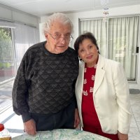 6-8-25 - Farrah residence, Millbrae - Passing of a torch - Joe Farrah (on left), long time Club secretary, talks with and passes the “torch” to incoming Secretary Zenaida Lawhon.