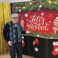 12-18-24 - 43rd Annual Lions Christmas with Santa at the Mission Education Center with Los Bomberos Firefighters - Lion Bob Lawhon posing and hamming it up with the Christmas display.