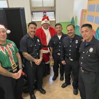 12-18-24 - 43rd Annual Lions Christmas with Santa at the Mission Education Center with Los Bomberos Firefighters - Members of Los Bomberos Firefighters, and Santa, waiting while the students have their lunch.